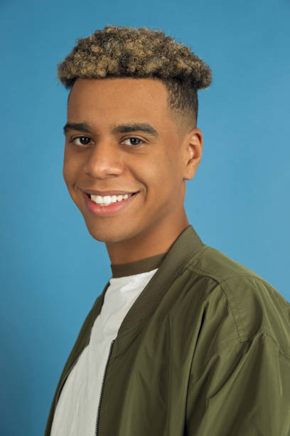 istock African-american man's portrait isolated on blue studio background 1200905798