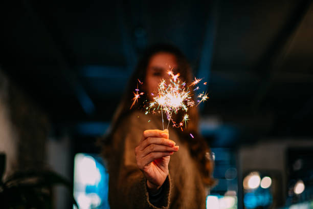 istock Brunette Woman Holding Sparkler 1200906804