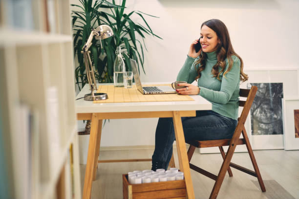 istock Young attractive female having phone call in modern office. 1200906981
