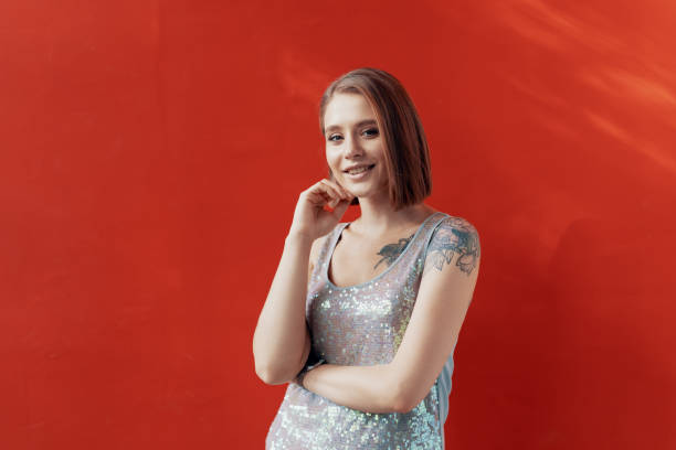 istock Cheerful young girl posing in front of a red wall 1200907047