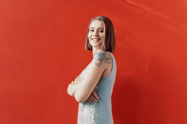 istock Cheerful young girl posing in front of a red wall 1200907052