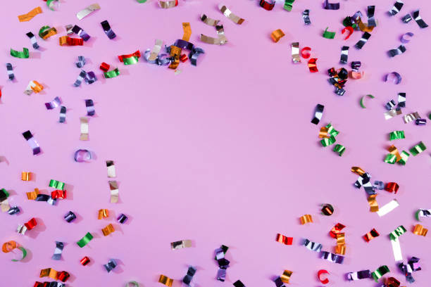 istock Colour sparkles on violet holiday background. Festive backdrop for your projects. 1200907233