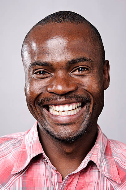 istock Happy young black man smiling in a pink shirt 120090810