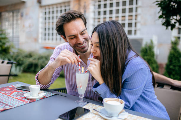 istock Couple in coffee shop drinking lemonade 1200909186