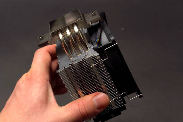 istock CPU cooling system. Cooler with a radiator in the hands of man 1200909643