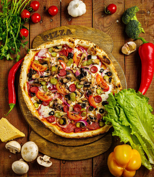 istock Fresh, handmade pizza on rustic wooden board 1200910243