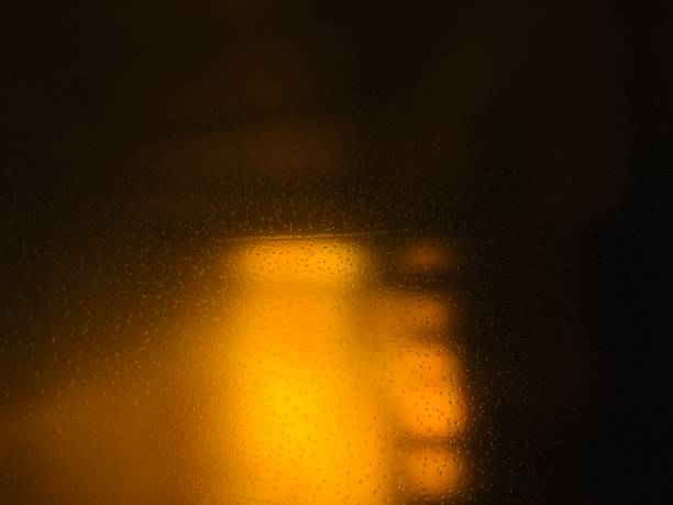 istock Clear glass is reflecting yellow light. 1200910804