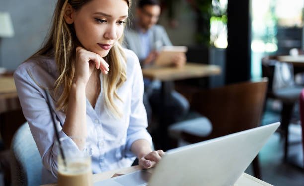 istock Happy young beautiful woman working, surfing, studying on laptop 1200911119
