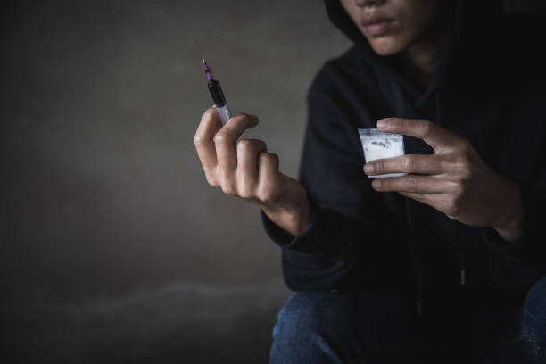 teenage girl is taking heroin, drug addict, disease , no to drugs,the concept of anti drugs,  26 june international day against drug abuse, - narcotic teenager cocaine drug abuse imagens e fotografias de stock