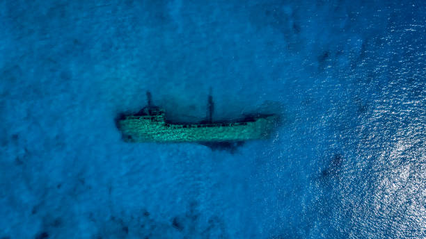 Aerial view of shipwreck underwater Shipwreck lying on the bottom of shallow sea water on south Peloponnese. View from above made with drone. sunken stock pictures, royalty-free photos & images