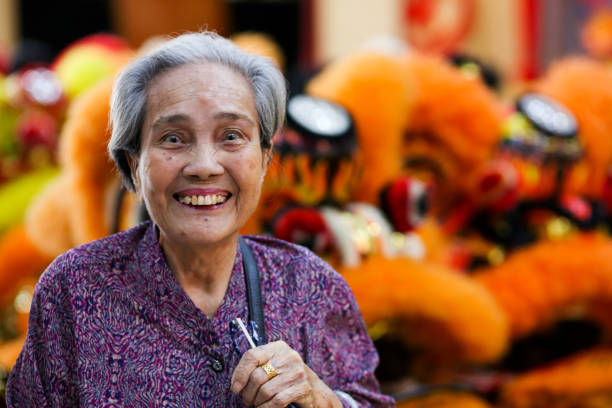 chinese new year: 18 lion dance heads on display - 80 year old imagens e fotografias de stock