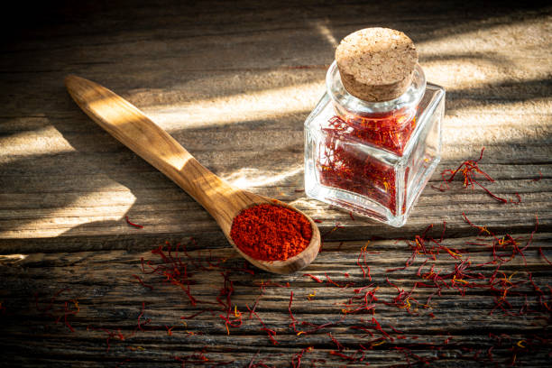 istock Saffron spice in glass bottle on rustic wooden table 1200912554