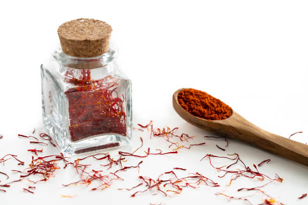 istock Saffron spice in glass bottle isolated on white 1200912689