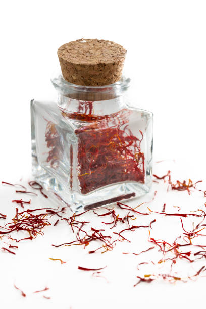 istock Saffron spice in glass bottle isolated on white 1200912722