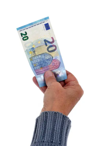 hand with a banknote in close-up on a white background