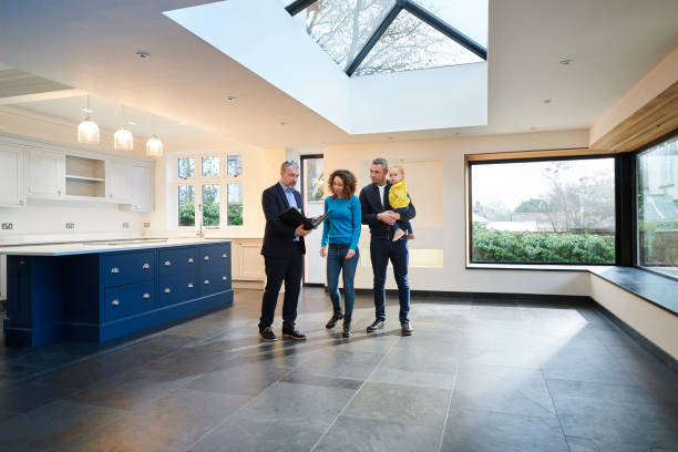 house viewing young family looking round new house with estate agent real estate agent male stock pictures, royalty-free photos & images