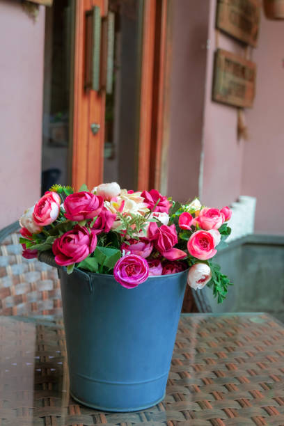istock roses in a bucket on the table 1200914325