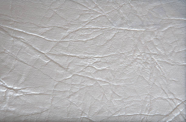 A fragment of natural leather processed and painted in light gray. A fragment of natural leather processed and painted in light gray. Close-up. leather white hide textured stock pictures, royalty-free photos & images