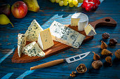 Blue cheese cutting board with knife on blue