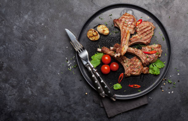 Grilled lamb ribs Grilled lamb ribs. Hot rack of lamb with spices and condiments. Top view on stone table with copy space rack of lamb stock pictures, royalty-free photos & images