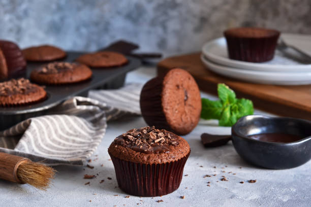istock Chocolate muffins with chocolate moss sauce and mint on a concrete background. 1200916655