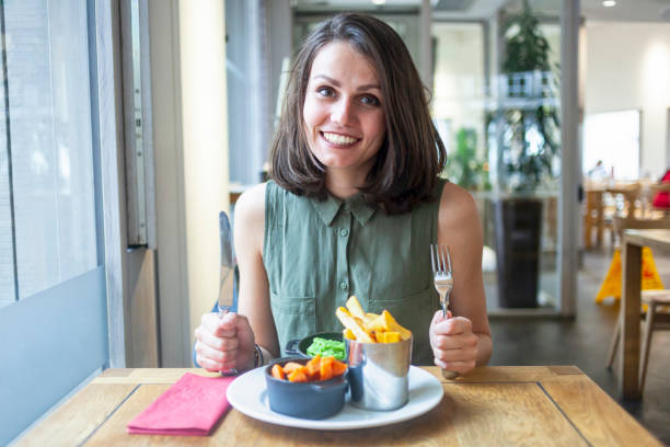 istock Young woman having lunch in restaurant 1200918060