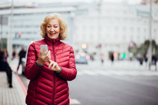 istock Fit senior female using the taxi application 1200919128