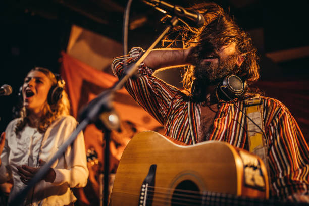 istock Man and lady musicians performing together on stage 1200919715