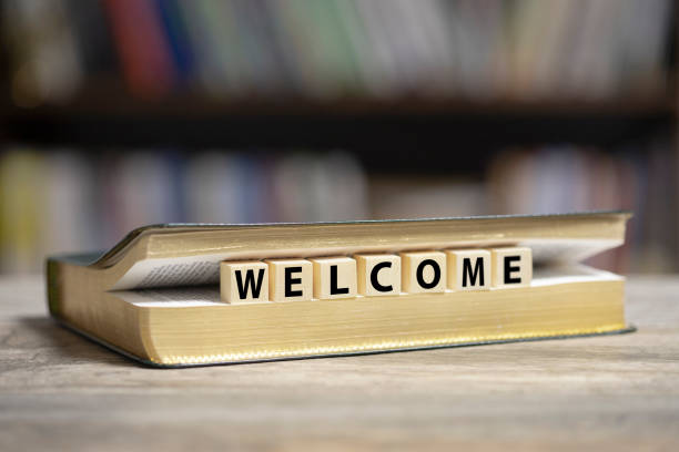 istock Book on desk with Welcome word 1200920524