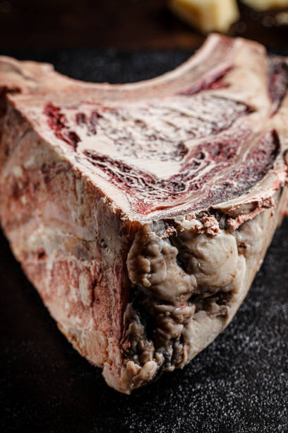 modern kitchen. dry aged beef, veal meat with red pepper and rosemary lies on a black background. board background image, copy space text, top view - scotch steak imagens e fotografias de stock