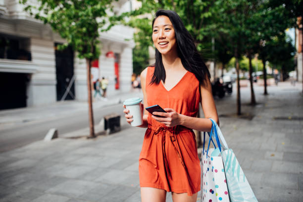 istock Beautiful Asian girl going back from shopping 1200920963