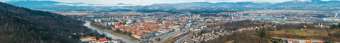 Beautiful Panorama of Town Celje, Slovenia\nCelje is the third-largest town in Slovenia. It is a regional center of the traditional Slovenian region of Styria and the administrative seat of the City Municipality of Celje (Slovene: Mestna občina Celje). The town of Celje is located below Upper Celje Castle (407 m or 1,335 ft) at the confluence of the Savinja, Hudinja, Ložnica, and Voglajna rivers in the lower Savinja Valley, and at the crossing of the roads connecting Ljubljana, Maribor, Velenje, and the Central Sava Valley.