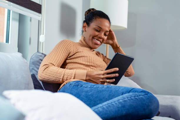 istock Happy African Woman Looking At Digital Tablet. 1200922659