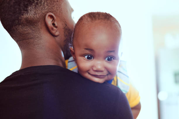 Shot of an adorable little boy spending quality time with his father at home