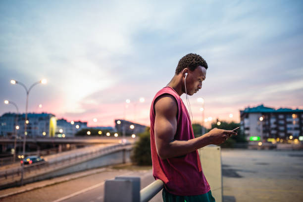 istock Young African american athlete texting after jogging 1200923044