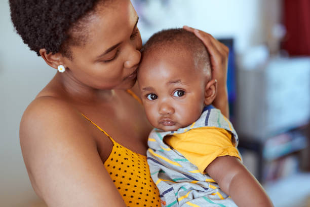 Mom makes everything feel better Shot of an adorable little boy spending quality time with his mother at home worried mom with kids stock pictures, royalty-free photos & images