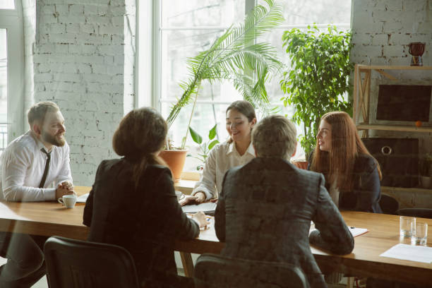 istock Group of young business professionals having a meeting, creative office 1200925559