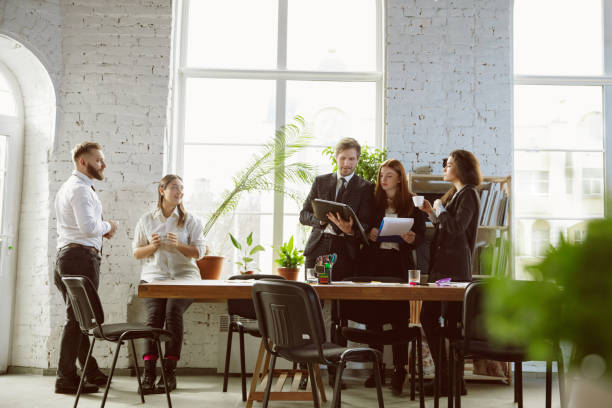 istock Group of young business professionals having a meeting, creative office 1200925599