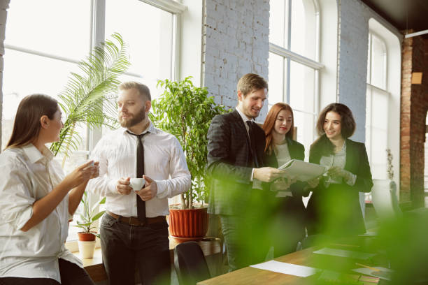 istock Group of young business professionals having a meeting, creative office 1200925601