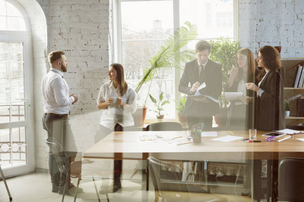 istock Group of young business professionals having a meeting, creative office 1200925604