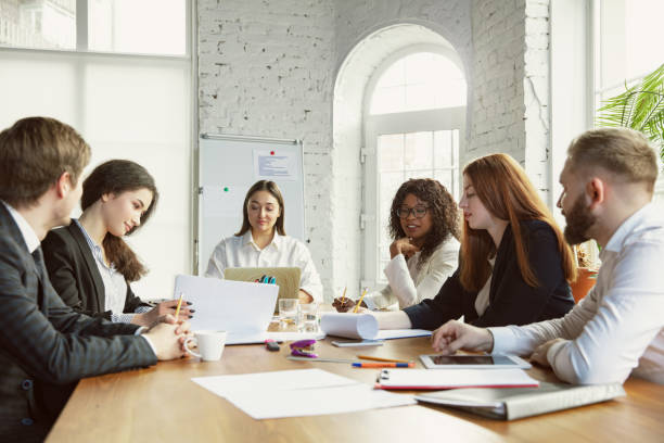 istock Group of young business professionals having a meeting, creative office 1200925622