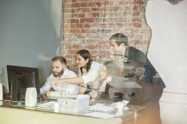 istock Group of young business professionals having a meeting, creative office 1200925632