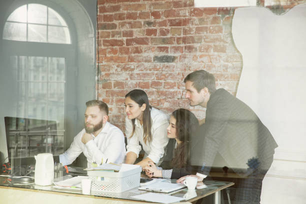 istock Group of young business professionals having a meeting, creative office 1200925633