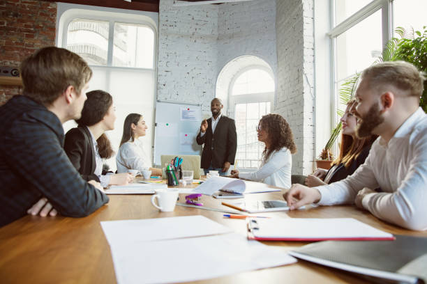 istock Group of young business professionals having a meeting, creative office 1200925670