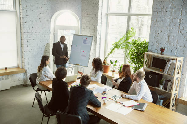 istock Group of young business professionals having a meeting, creative office 1200925689