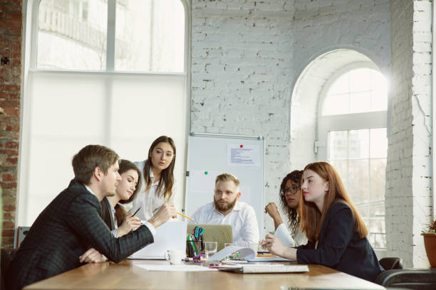 istock Group of young business professionals having a meeting, creative office 1200925713