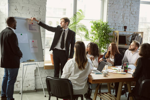 istock Group of young business professionals having a meeting, creative office 1200925724