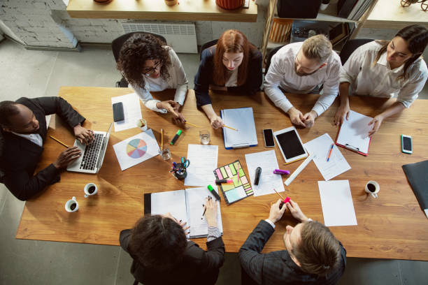 istock Group of young business professionals having a meeting, creative office 1200925746
