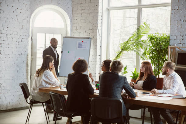 istock Group of young business professionals having a meeting, creative office 1200925751