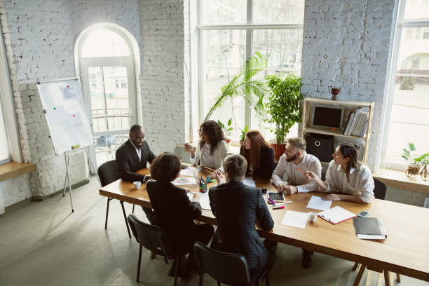 istock Group of young business professionals having a meeting, creative office 1200925770